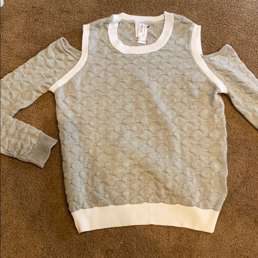Cute Cold Shoulder sweater with white trim.